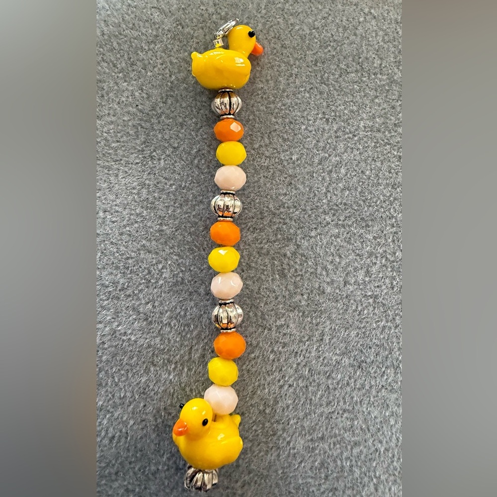 Colorful Duckie Beads on a lobster clasp. Approx 3 inches long.